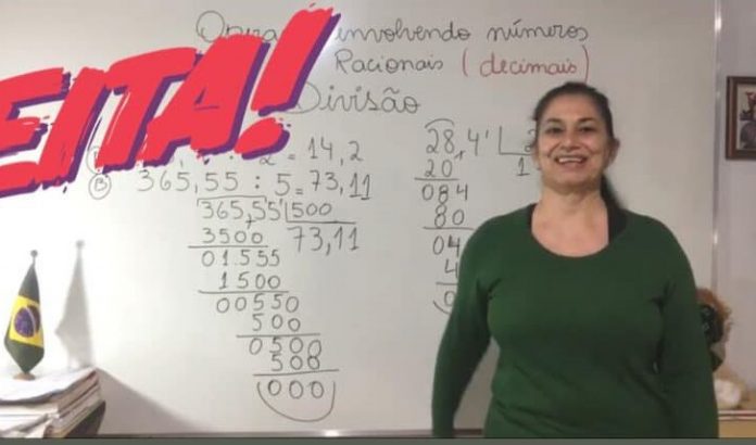 #Pracegover Foto: Professora Katia Urbano em frente ao quadro com ensinamentos de matemática